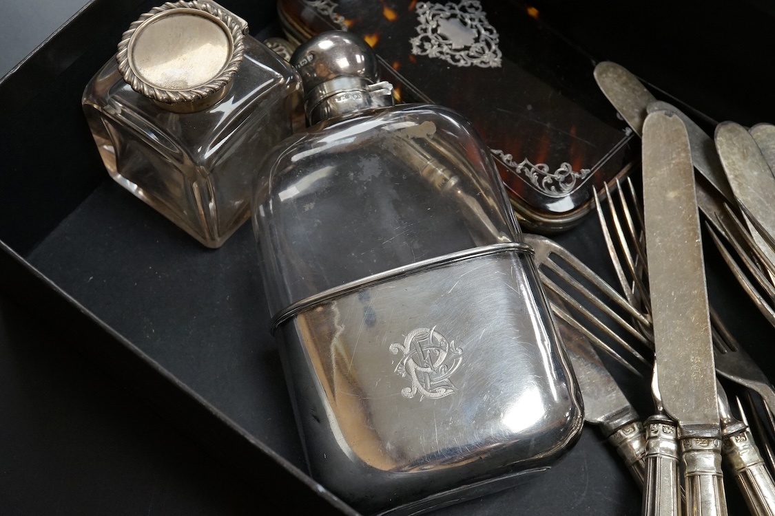 A late Victorian silver mounted glass hip flask, James Dixon & Sons, Sheffield, 1891, 15.5cm (lead solder), together with a silver mounted glass inkwell, assorted silver handled plated dessert eaters(a.f.) and a tortoise